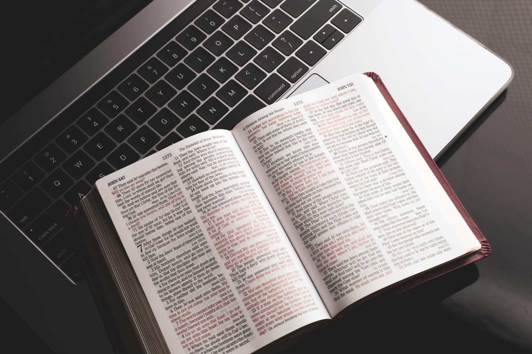 An open Bible resting on a laptop, opened for daily study